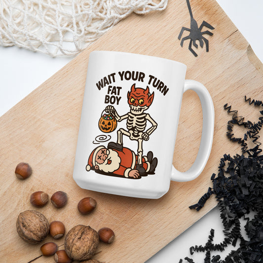 15 oz White mug with Halloween-themed design of a Skeleton wearing a mask standing over Santa with the text “Wait your turn Fat Boy”