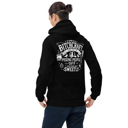Back  View: Person wearing Black Hoodie with witchy text graphic Text: Bitchcraft The Art of Pissing people off and smiling sweetly Sizes: Small to 5XL