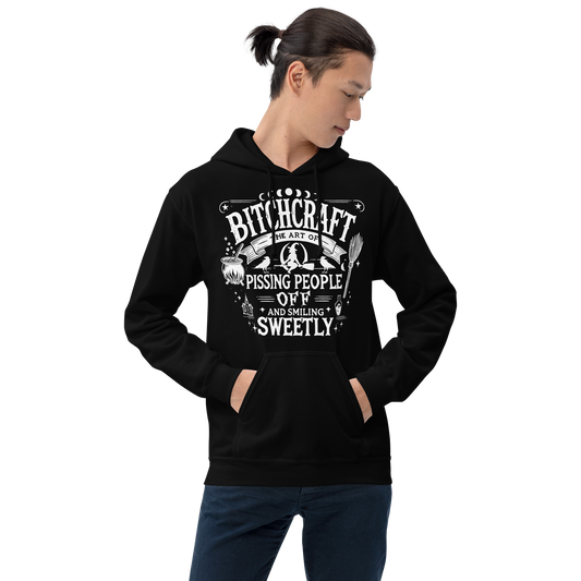 Front View: Person wearing Black Hoodie with witchy text graphic Text: Bitchcraft The Art of Pissing people off and smiling sweetly Sizes: Small to 5XL