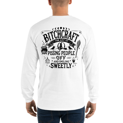 Back View: Person Wearing a White Long Sleeve Shirt With a Witchy Graphic Text: Bitchcraft: Pissing People off  and smiling Sweetly Sizes: Small to 4XL